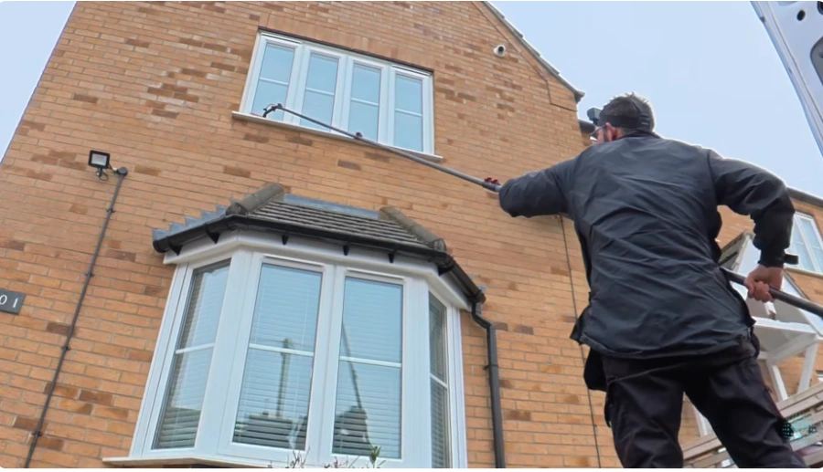 Technician cleaning window screens in San Clemente
